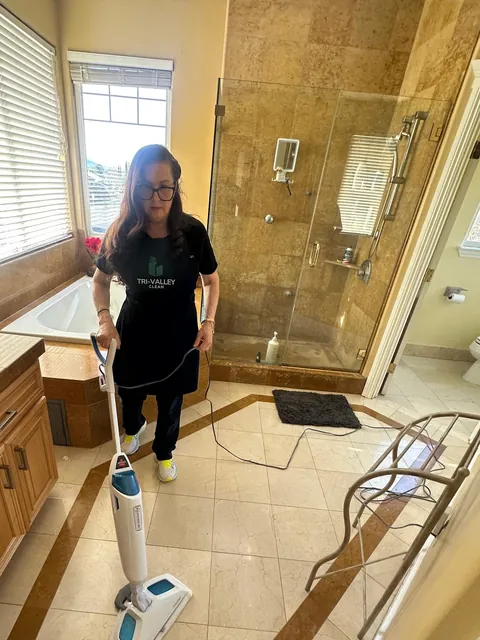 Mopping a bathroom floor in a Tri-Valley home