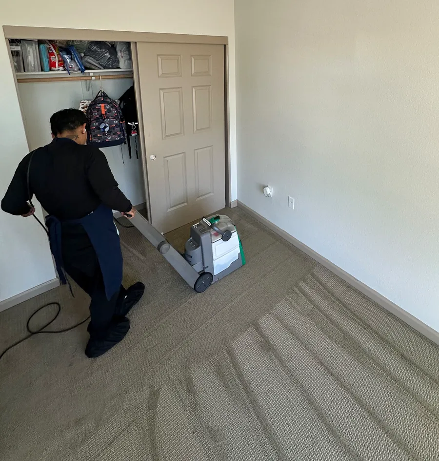 Carpet cleaning a bedroom, with fresh clean lines in the carpet
