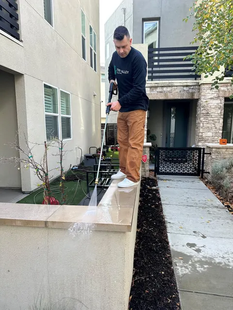 Pressure washing a front entry wall