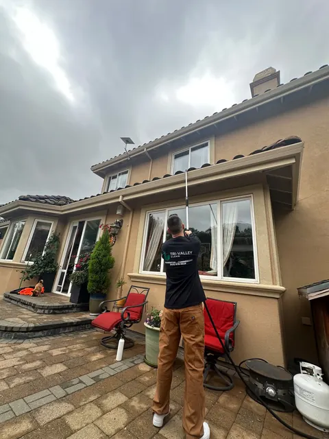 Second-story window cleaning with a water-fed pole