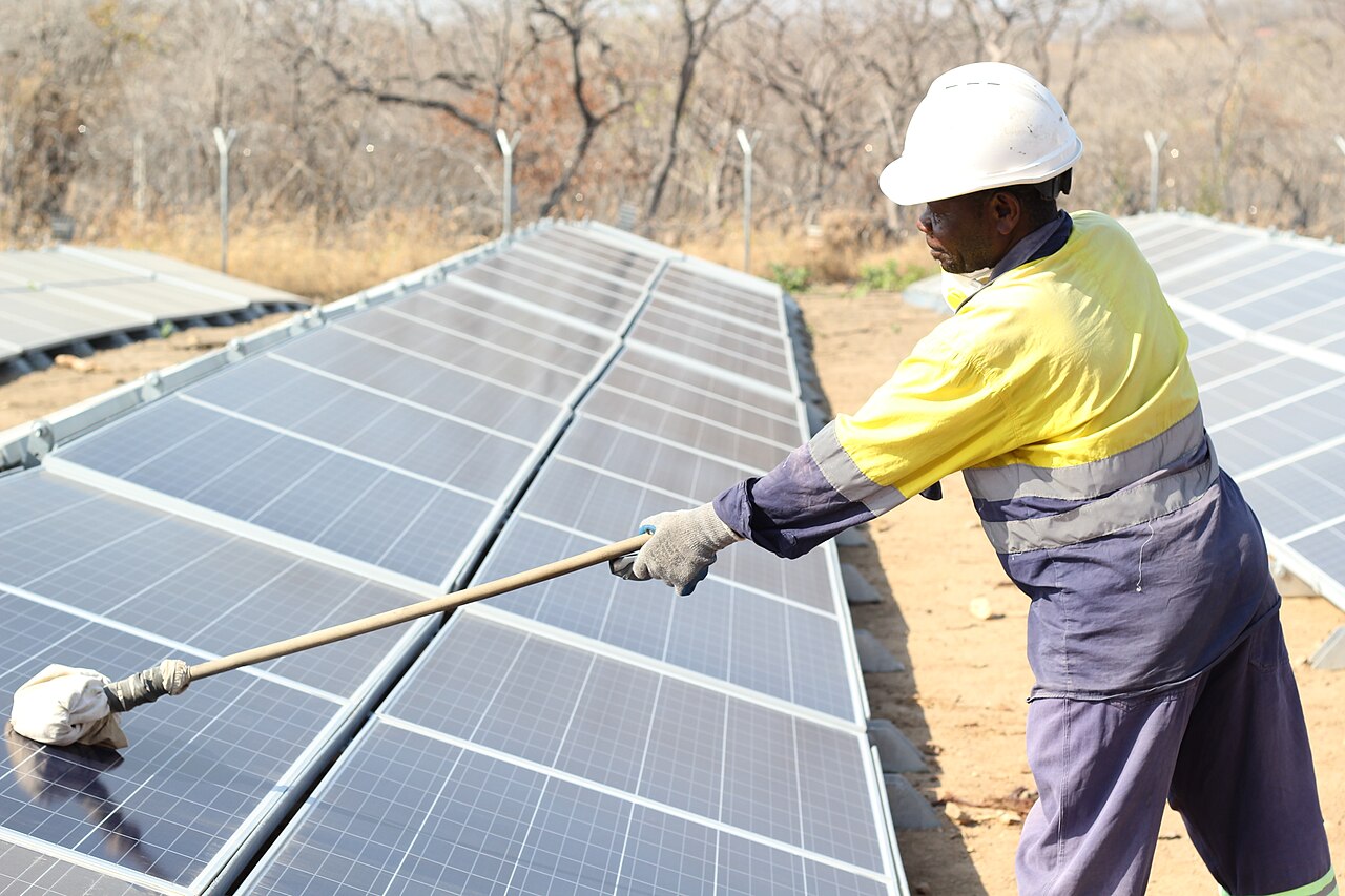 Cleaning solar panels with a soft brush pole