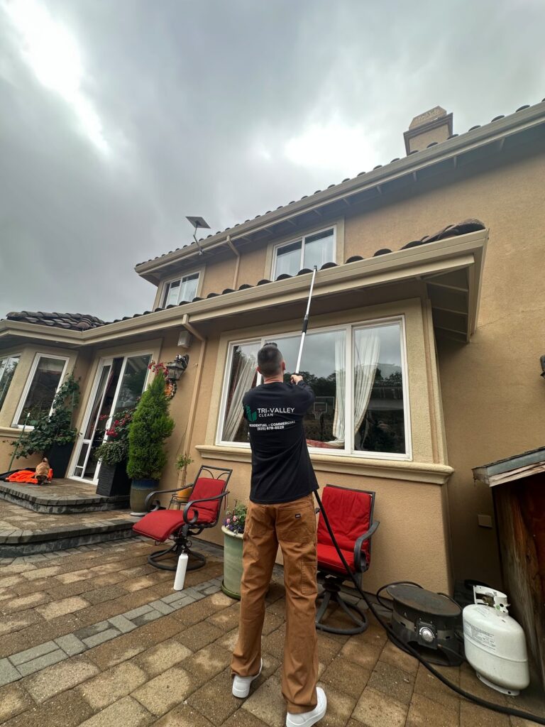 Cleaning second-story windows with a water-fed pole