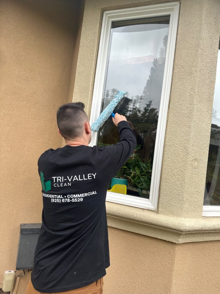 Tri-Valley Clean technician squeegeeing an exterior window